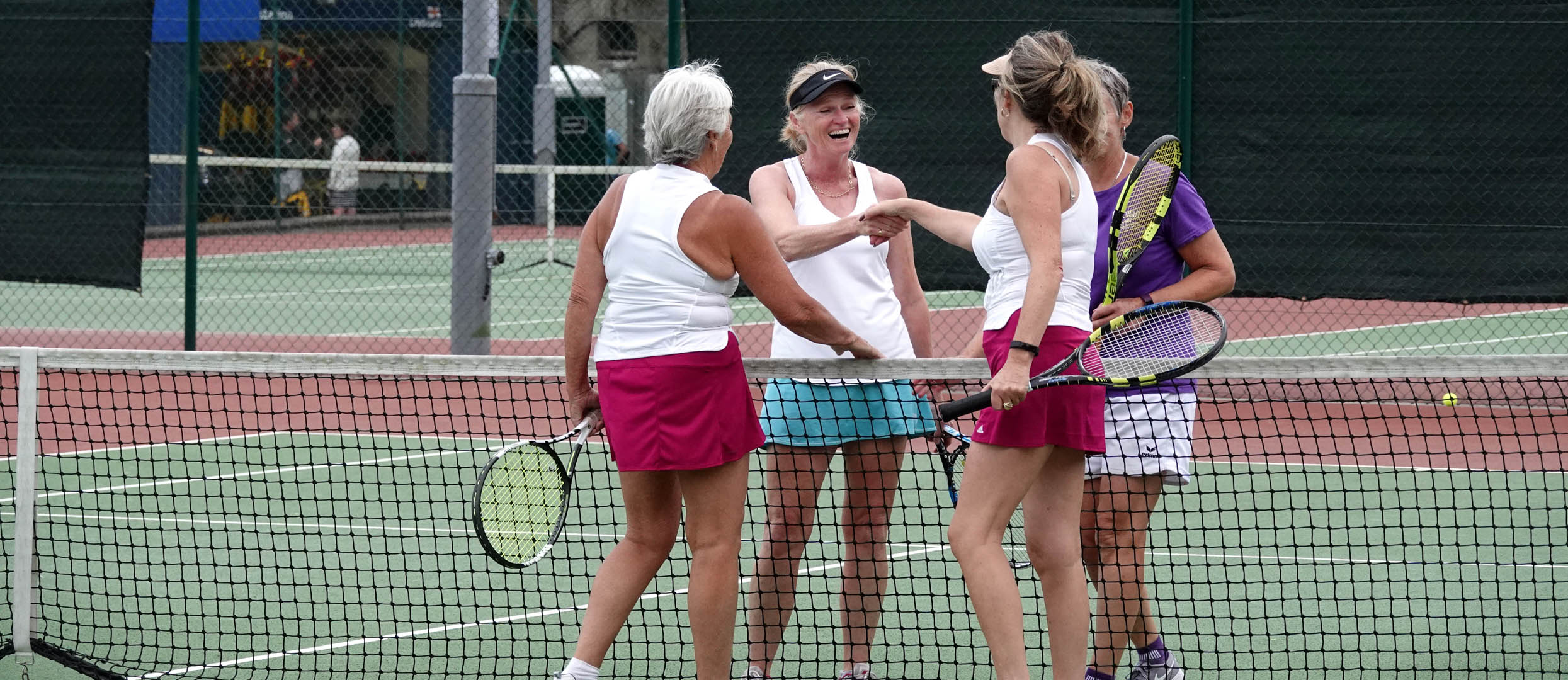 A player volleys at the net during Wednesday Afternoon social tennis