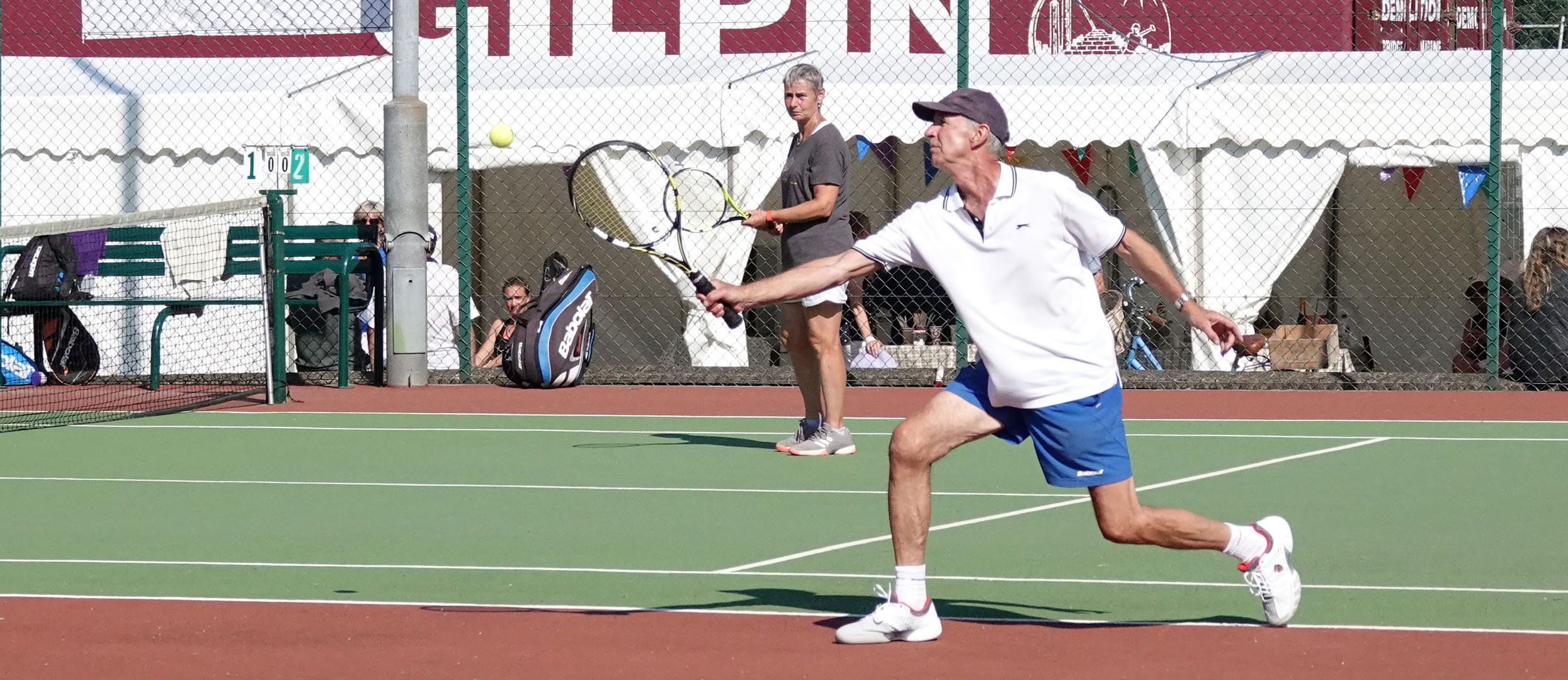 A player returns the ball at the net during Monday Afternoon social tennis